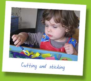 My daughter cutting and sticking